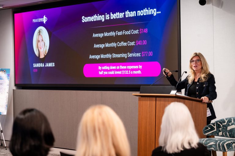 Sandra James speaking at a podium in front of a presentation slide
